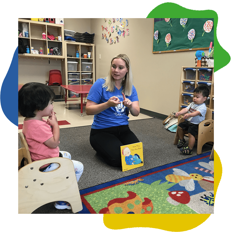 Children learning sign language with a teacher.