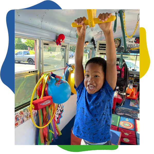 Preschool child hanging from bars in Studio Tumble Jungle